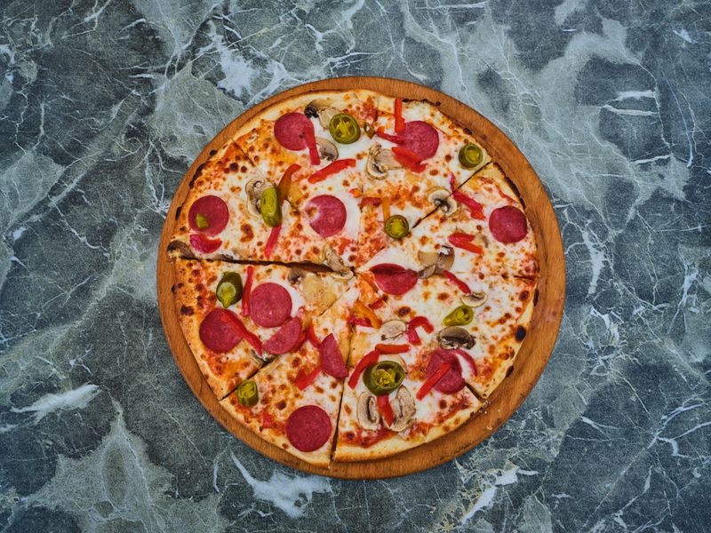 Pepperoni Supreme pizza loaded with toppings at Papa Ginos